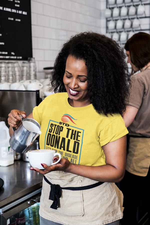 Woman wearing yellow stop the donald t-shirt